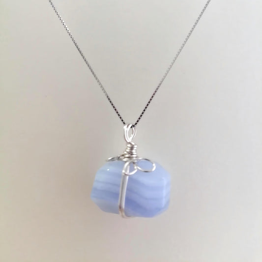 Necklace with a blue pendant on a light gray background