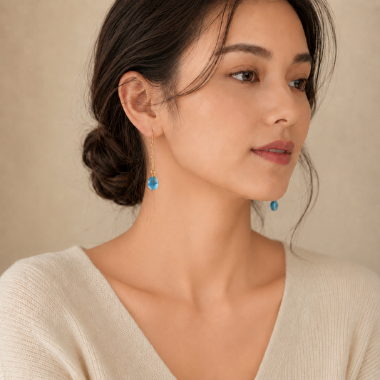 Woman wearing Aquamarine earrings with a neutral background