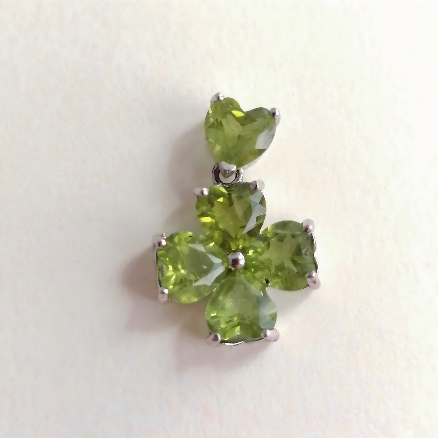 Green gemstone pendant on a white background