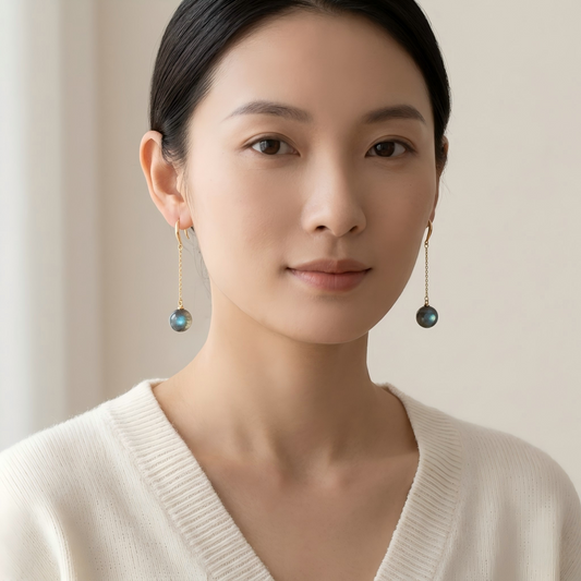Woman wearing elegant earrings with a neutral background
