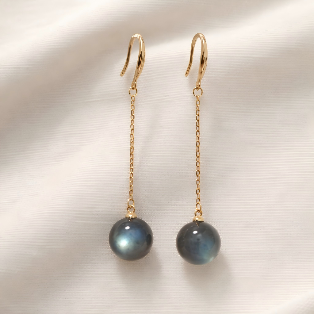 Gold earrings with Labradorite beads on a textured white background