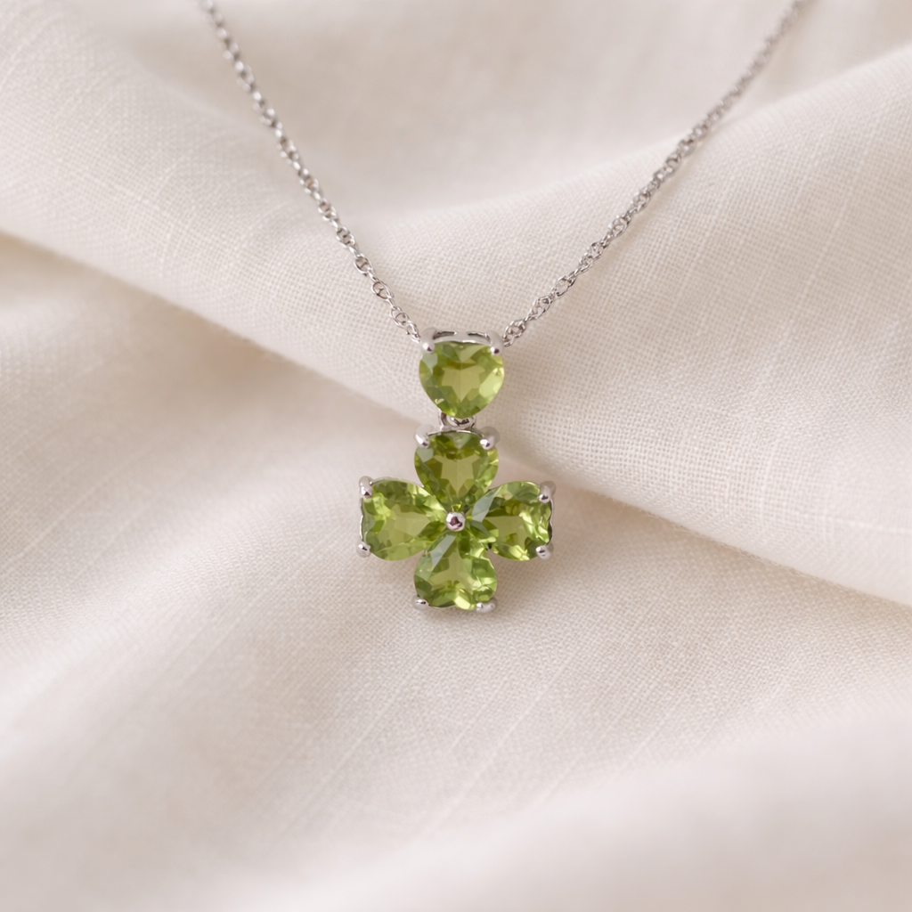Green gemstone necklace on a beige fabric background