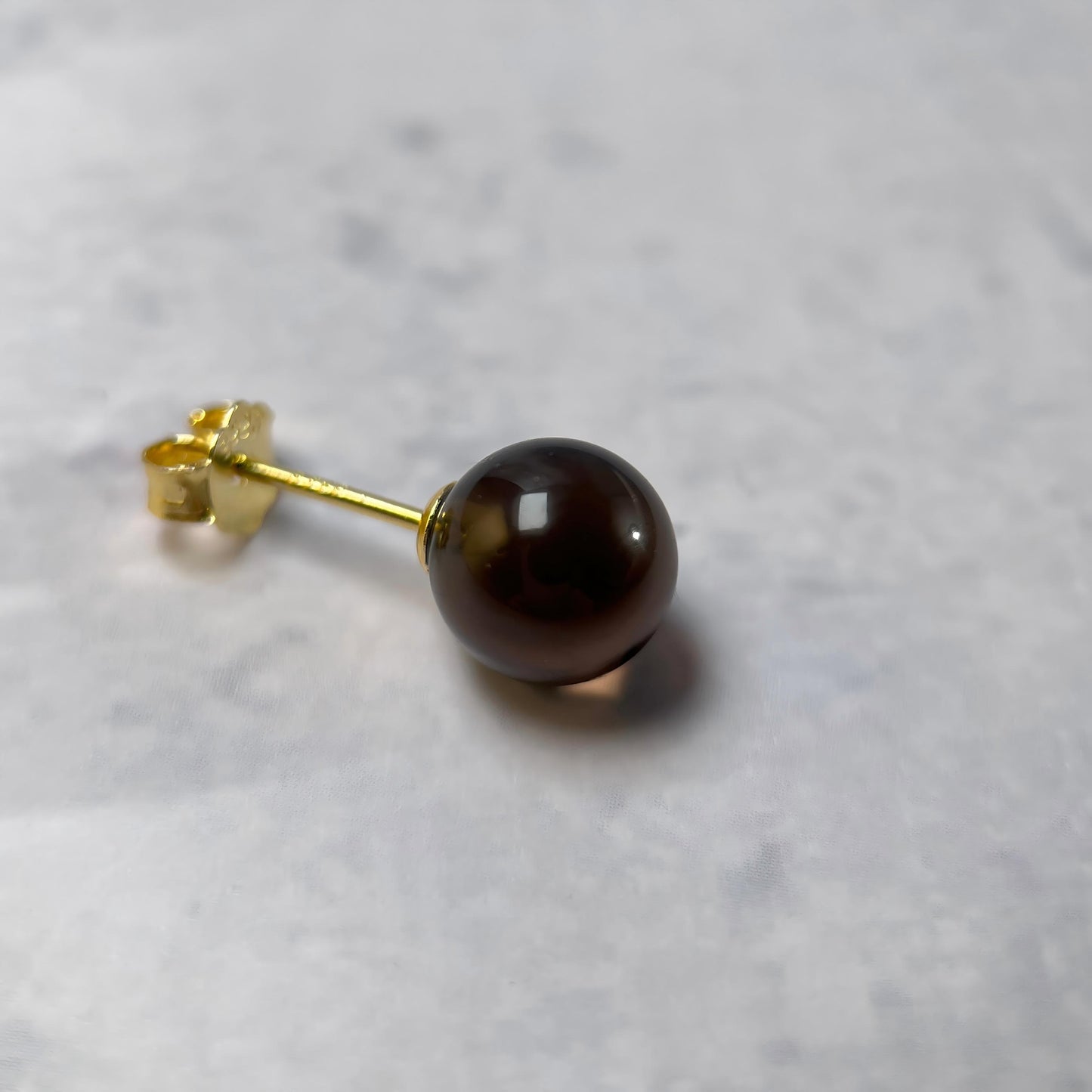 Close-up of Warm Shade smoky quartz stud earring with 8mm warm brown quartz bead