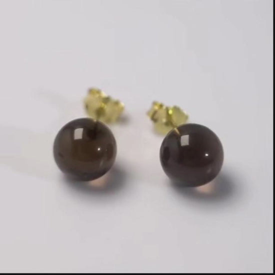 A pair of two-way smoky quartz earrings in gold-plated sterling silver — simple as studs, softer as long drops